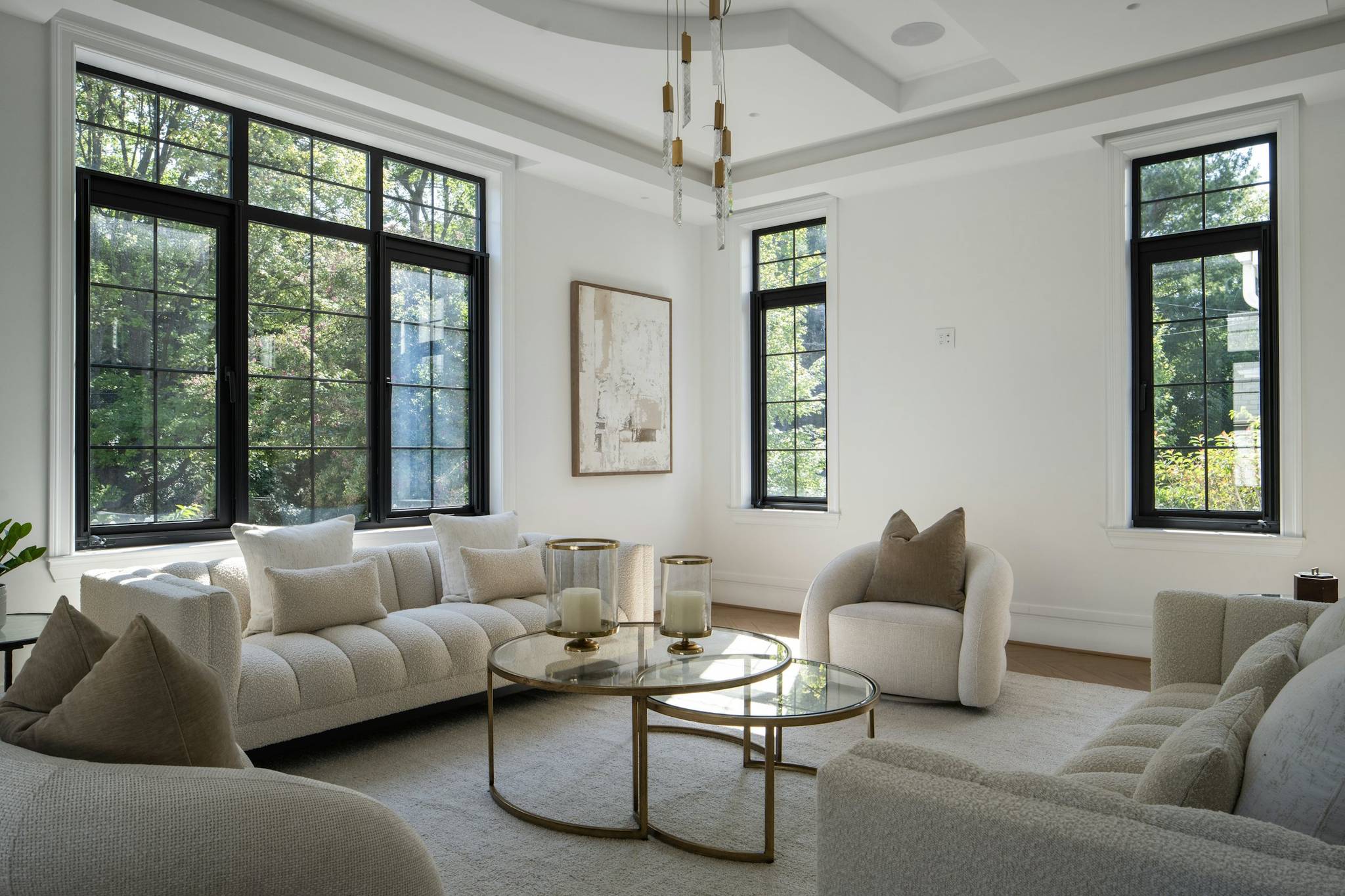 Elegant living room with light furniture and large windows